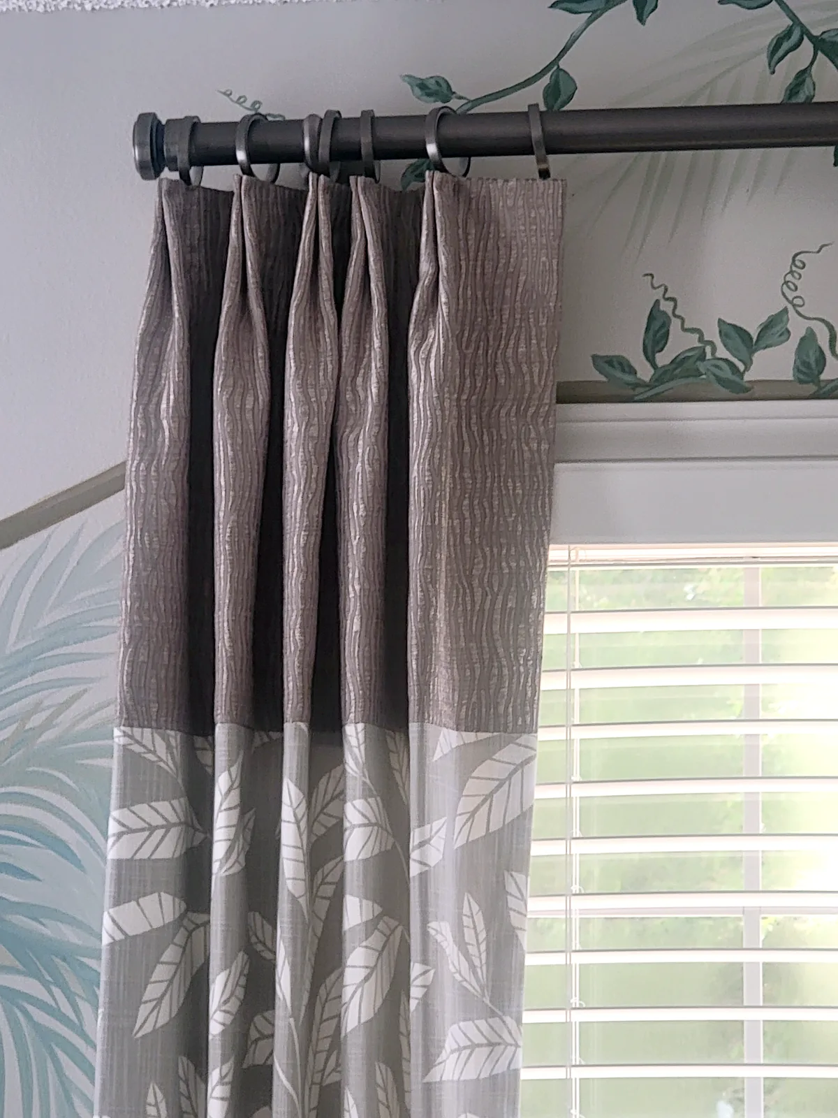 Custom banded drapery panel with leaf print fabric against a hand painted safari mural